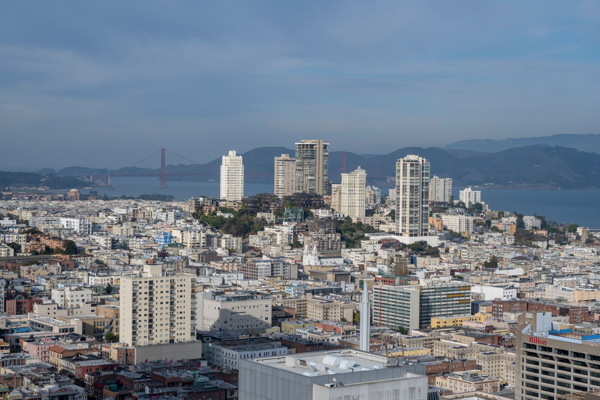 Aerial view of city skyline, bay and hills